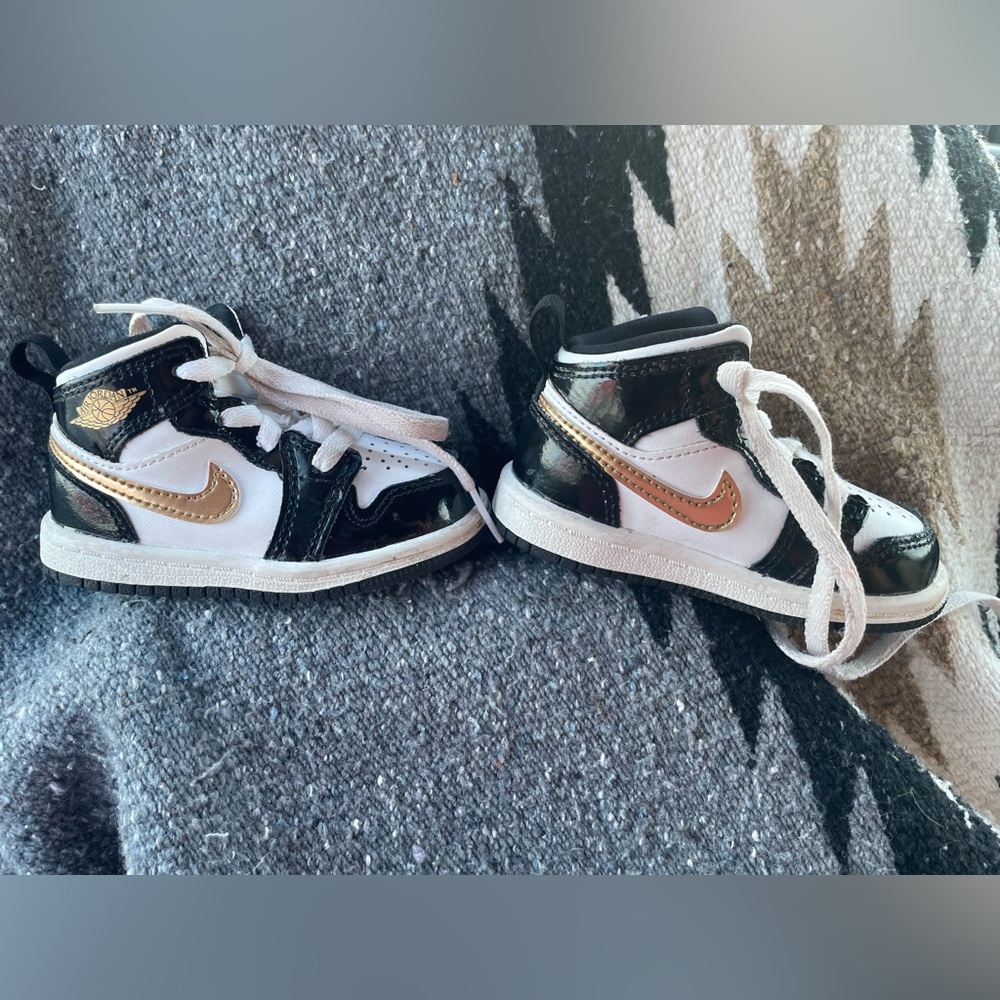 Nike Air Jordan 1 Mid SE in the "Black Metallic Gold" colorway